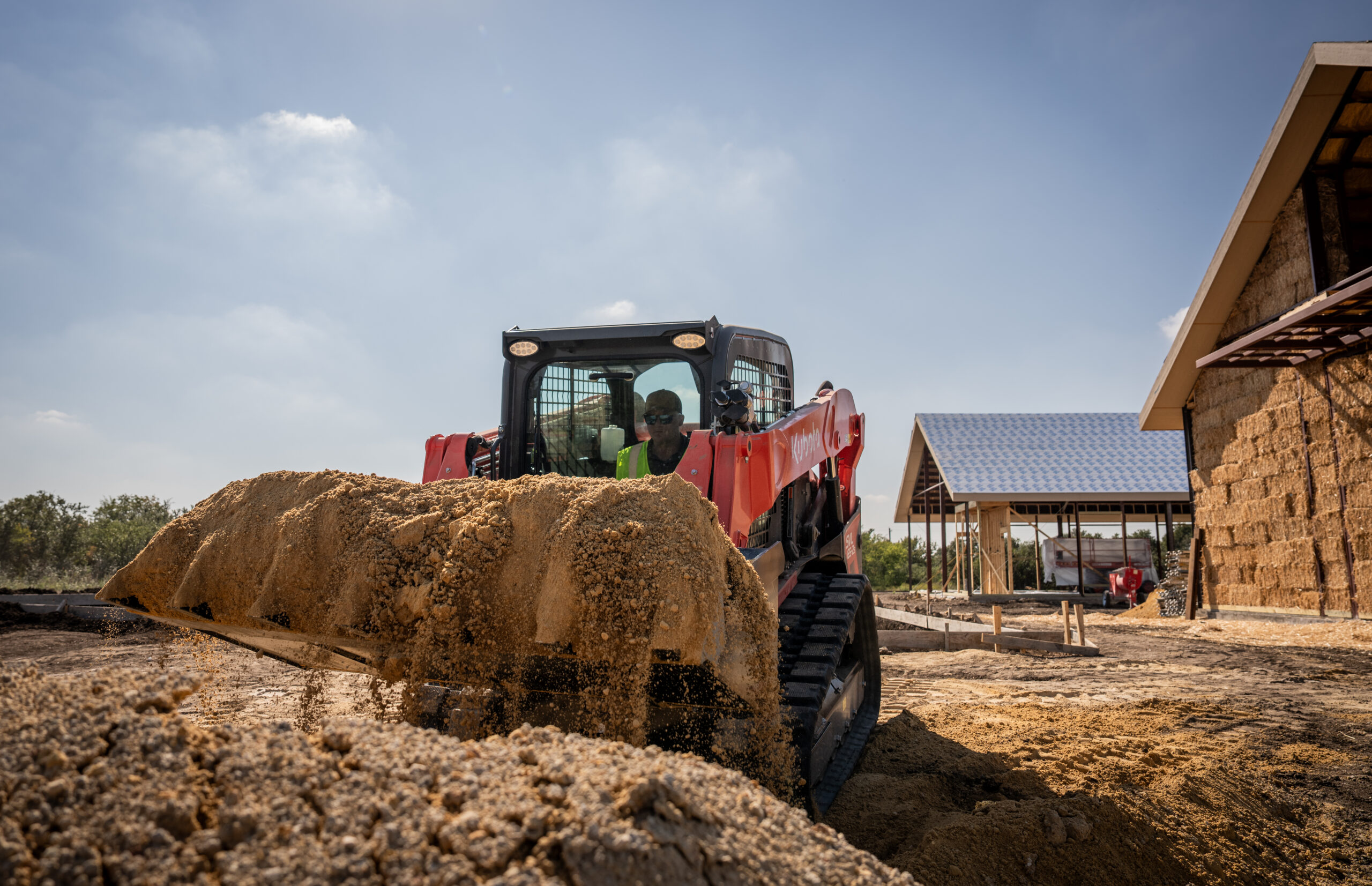 Kubota compact construction equipment working on a property